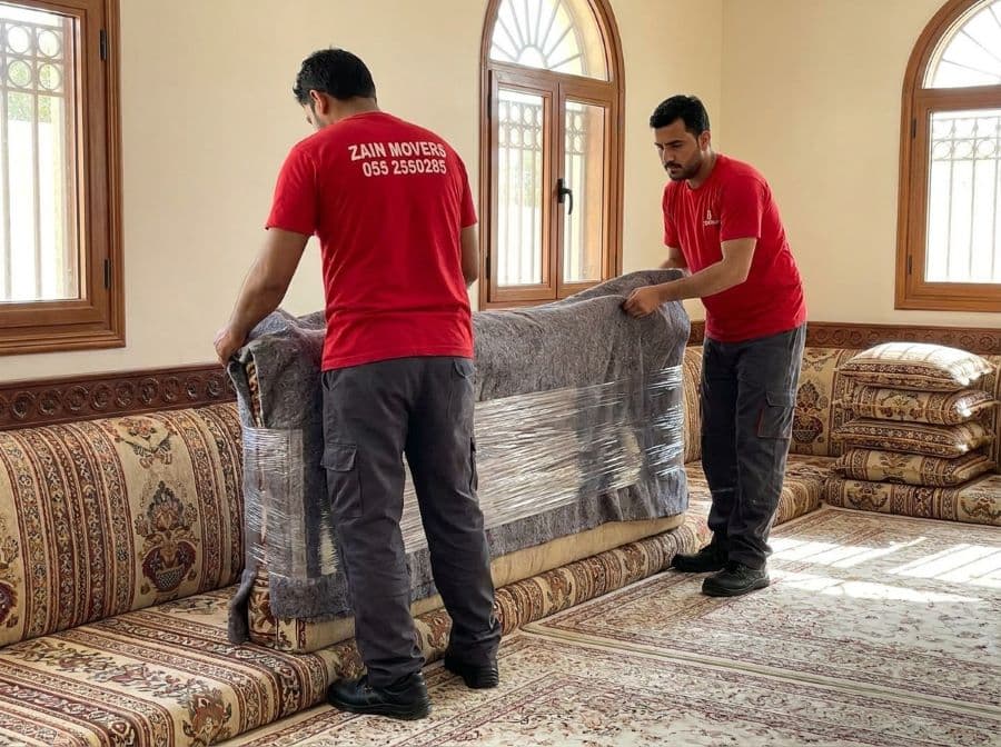 Zain Movers crew wrapping majlis seating inside an Al Ain villa