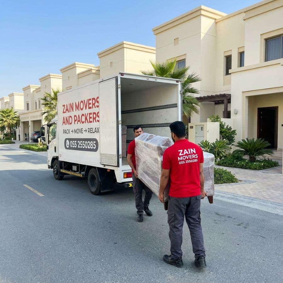 Zain Movers crew loading wrapped furniture outside a Cedre Villas home in DSO