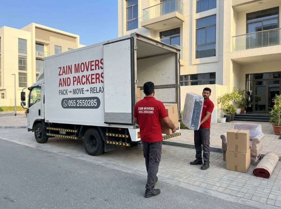 Zain Movers crew loading a studio apartment move into a branded truck in Dubai