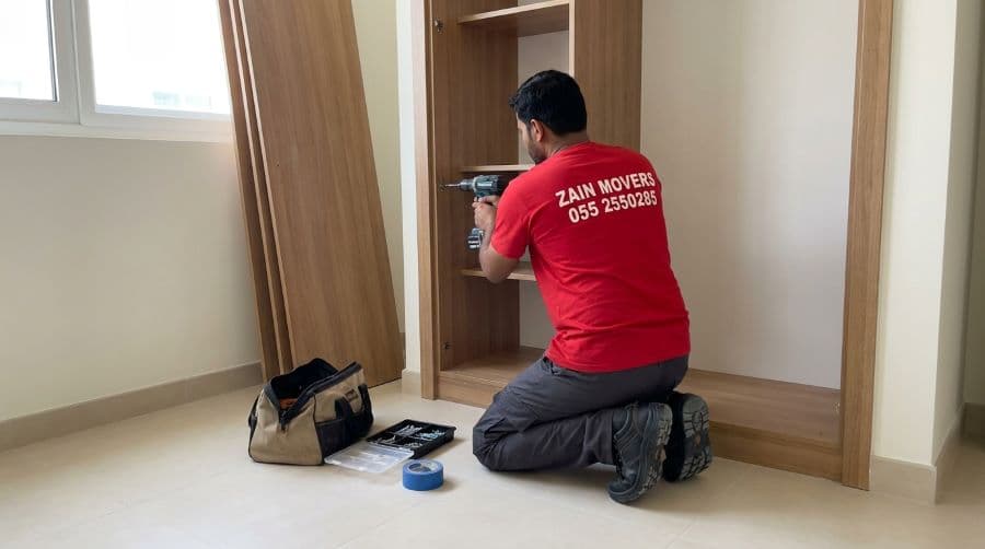 Carpenter dismantling a wardrobe inside a Cedre Villas bedroom